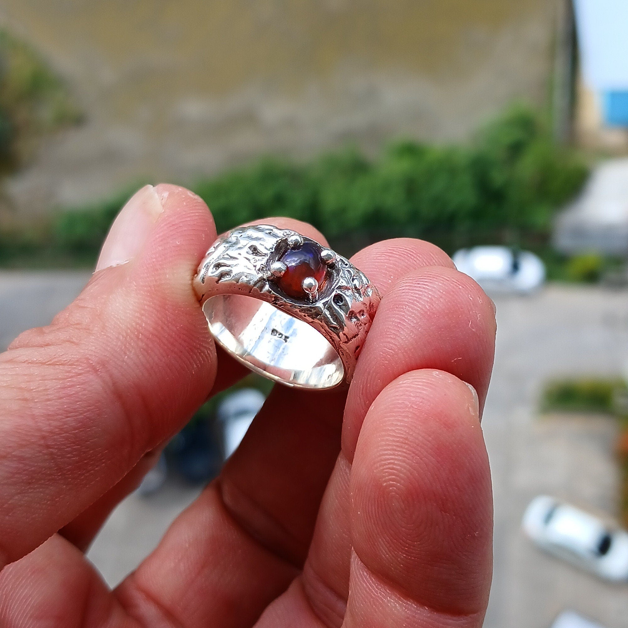 A handcrafted sterling silver ring featuring a vibrant multi-color opal stone, elegantly polished for a timeless look.