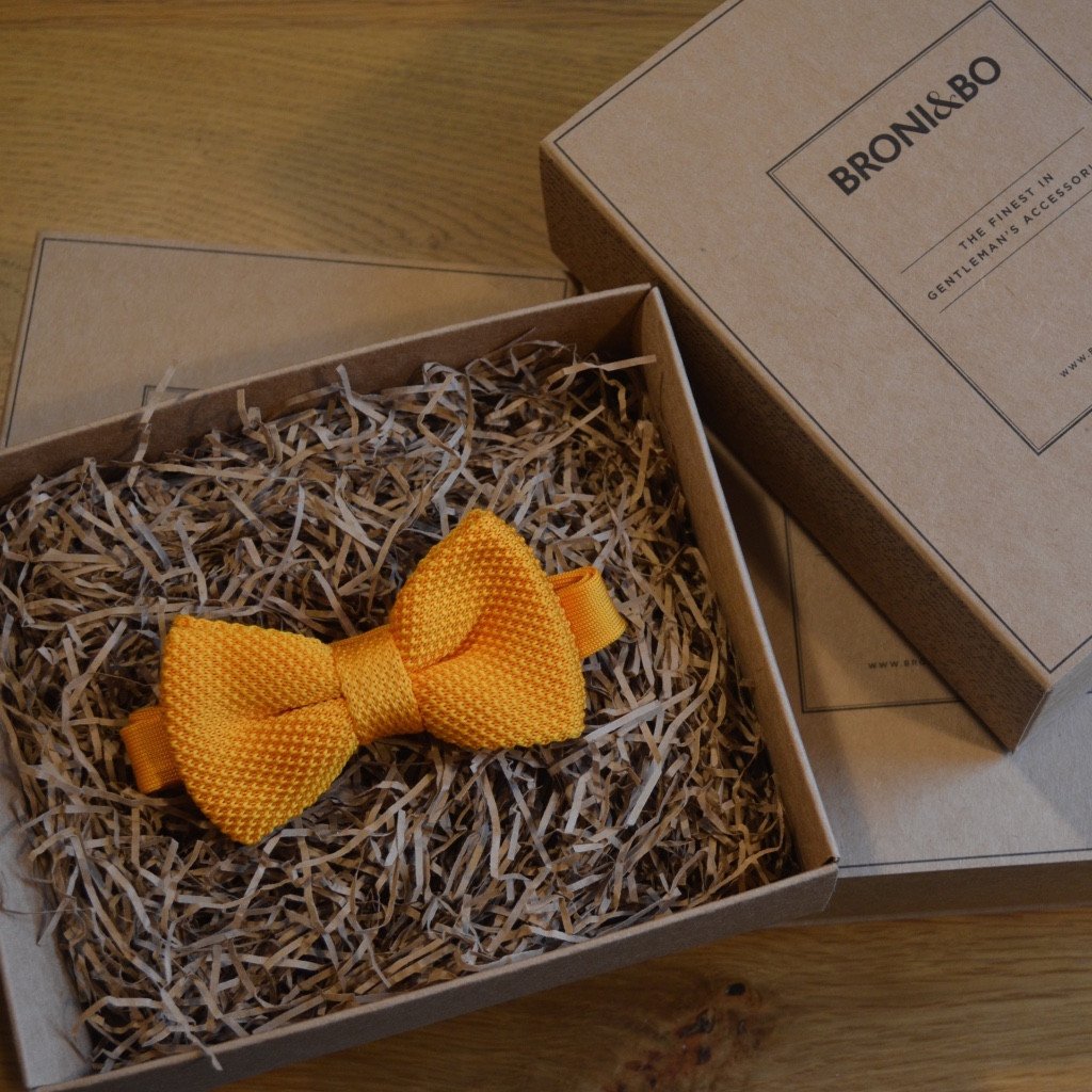 An elegant orange knitted wedding bow tie, pre-tied and adjustable, perfect for grooms and groomsmen.