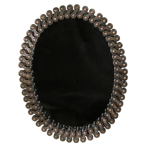 Oval mirror framed with recycled bicycle chains, handcrafted by artisans in India, showcasing unique design and sustainable craftsmanship.