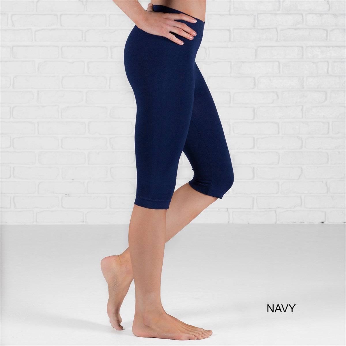 Over Knee Crop Shorts Leggings in various colors, showcasing their stretchy fabric and over-the-knee design.