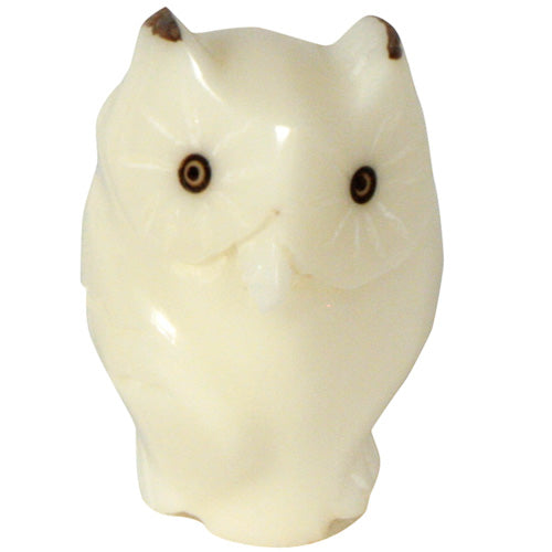 Hand-carved owl figurine made from tagua nuts, showcasing natural colors and intricate details, symbolizing eco-friendliness and artisan craftsmanship.