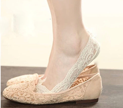 A pair of lace non-slip footsies featuring a delicate floral trim, designed for comfort and style.