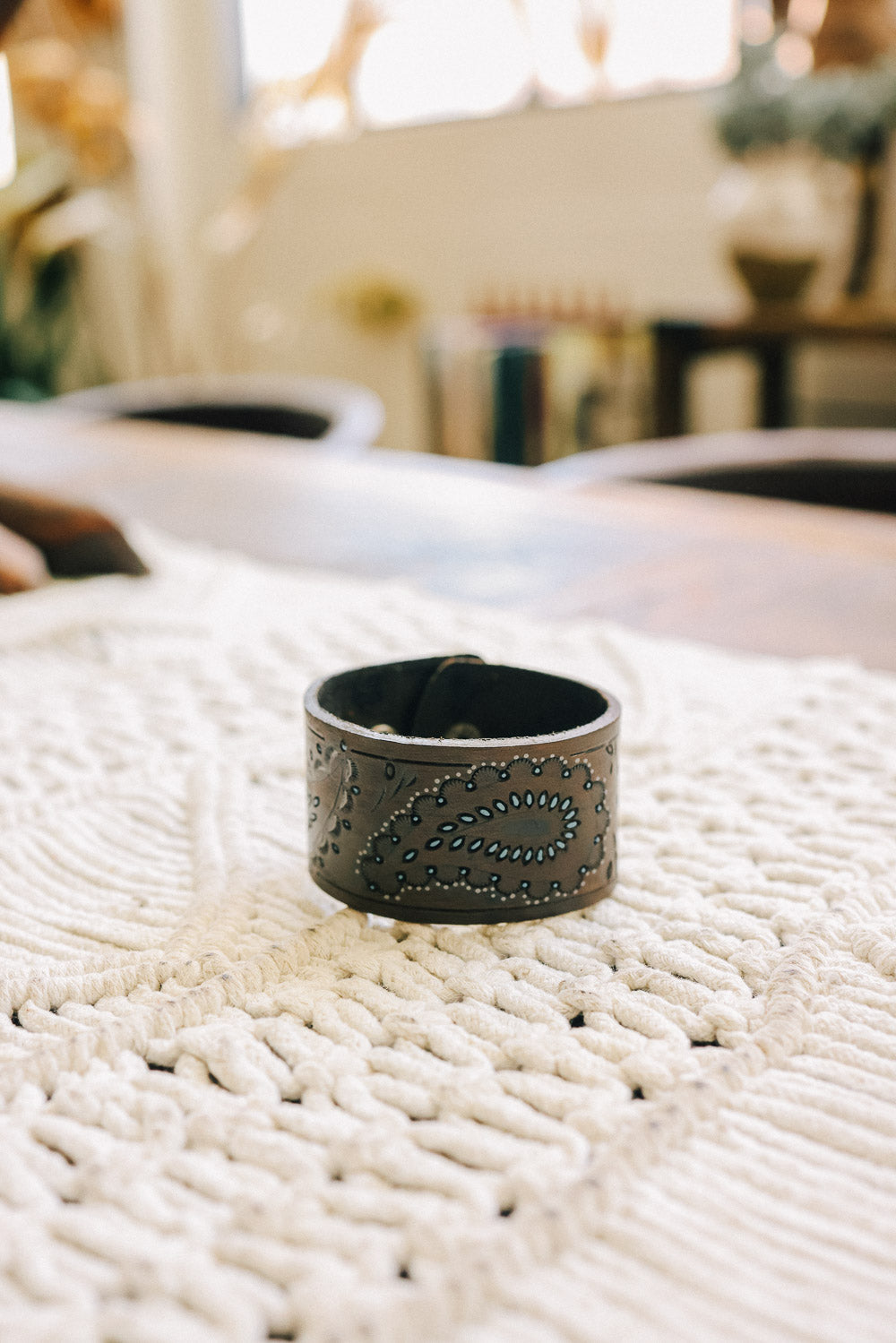 A beautifully designed paisley pressed leather cuff bracelet showcasing vibrant colors and intricate patterns, perfect for bohemian style.