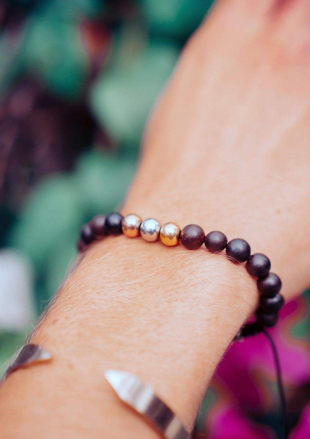 The Palm Band bead bracelet featuring colorful beads and a palm tree anchor link, symbolizing positivity and happiness.