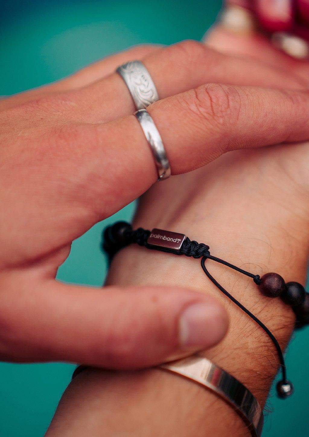 The Palm Band bead bracelet featuring colorful beads and a palm tree anchor link, symbolizing positivity and happiness.