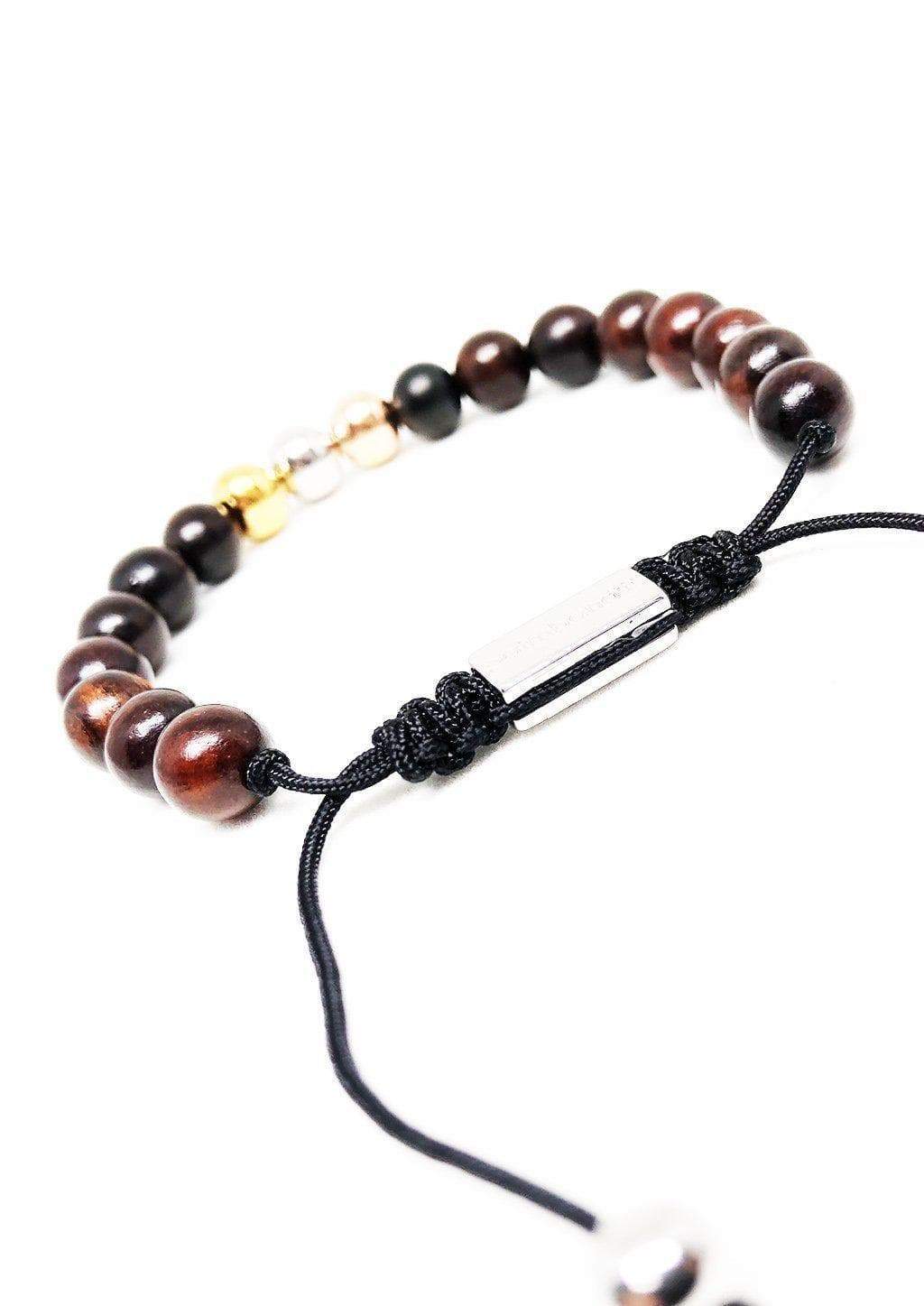 The Palm Band bead bracelet featuring colorful beads and a palm tree anchor link, symbolizing positivity and happiness.