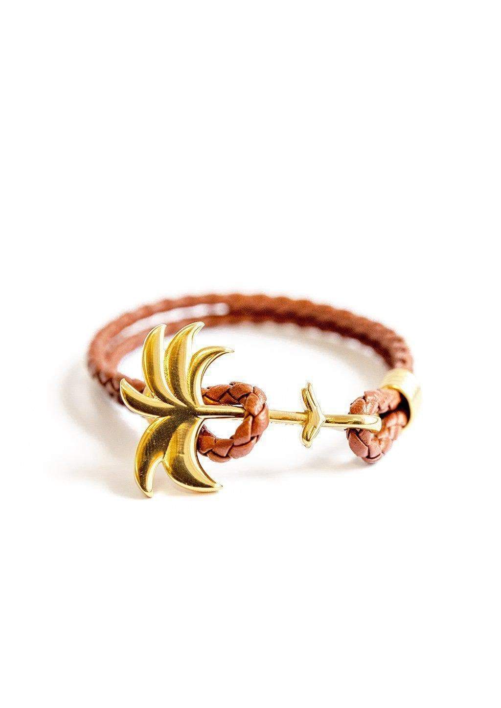 Palm Band - Sunrise Gold featuring a gold palm tree anchor on a thick braided brown leather bracelet, symbolizing positivity and happiness.