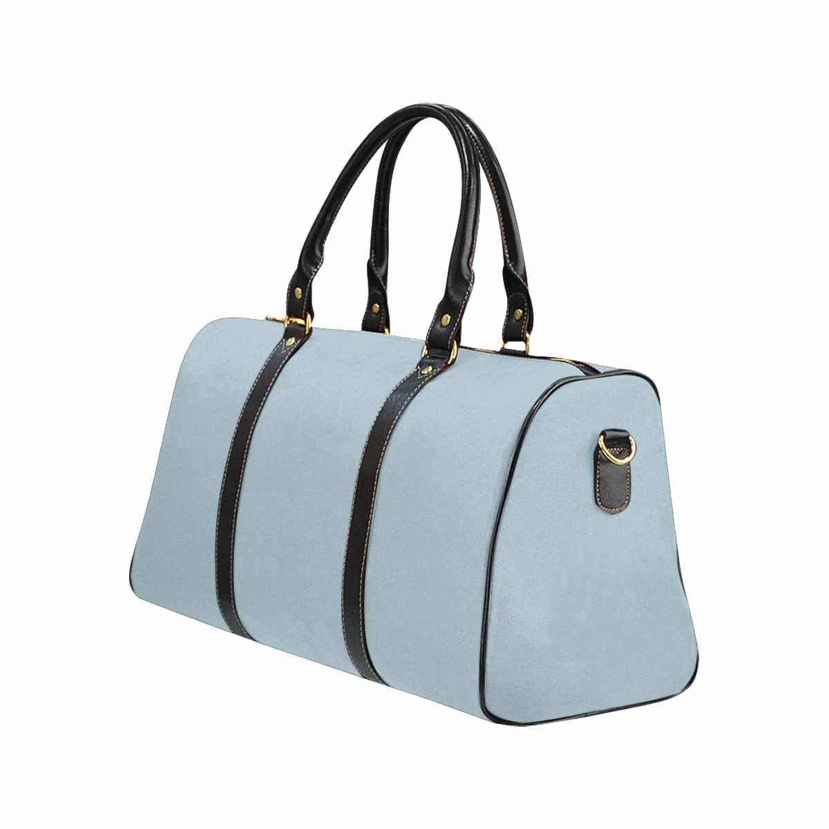 Pastel blue travel bag with adjustable black strap, showcasing its spacious design and durable waterproof fabric.