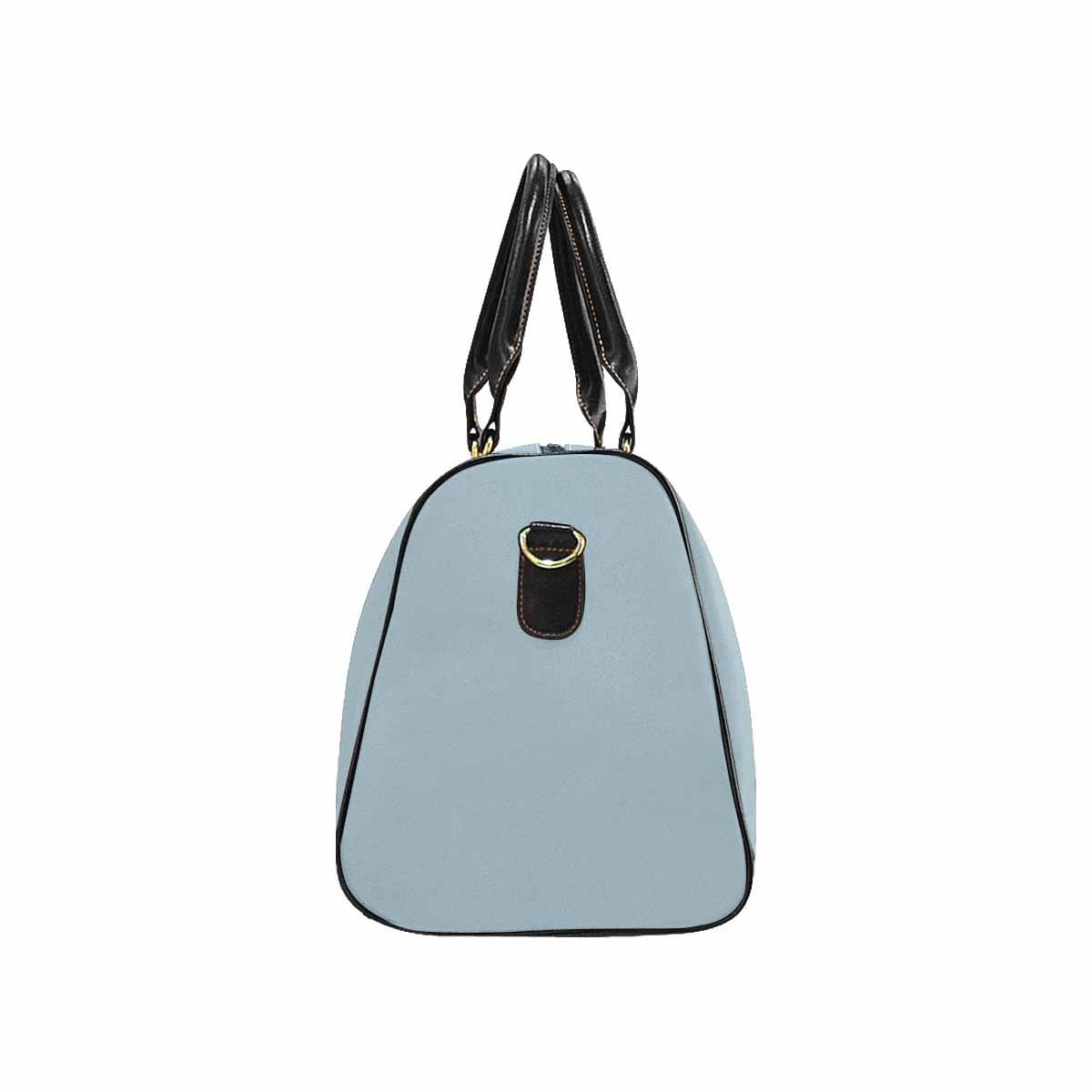 Pastel blue travel bag with adjustable black strap, showcasing its spacious design and durable waterproof fabric.