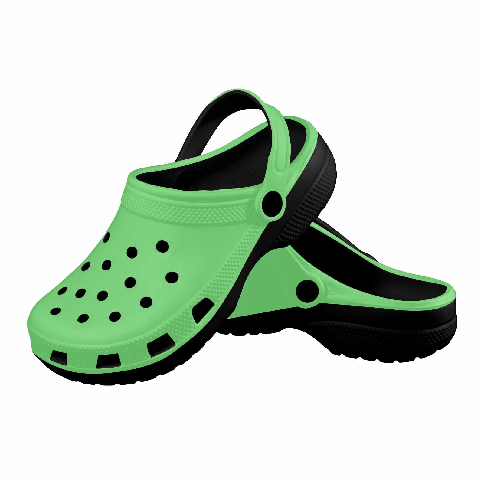 Pastel Green Adult Clogs made from lightweight EVA material, featuring ventilation ports and pivoting heel straps for a secure fit.