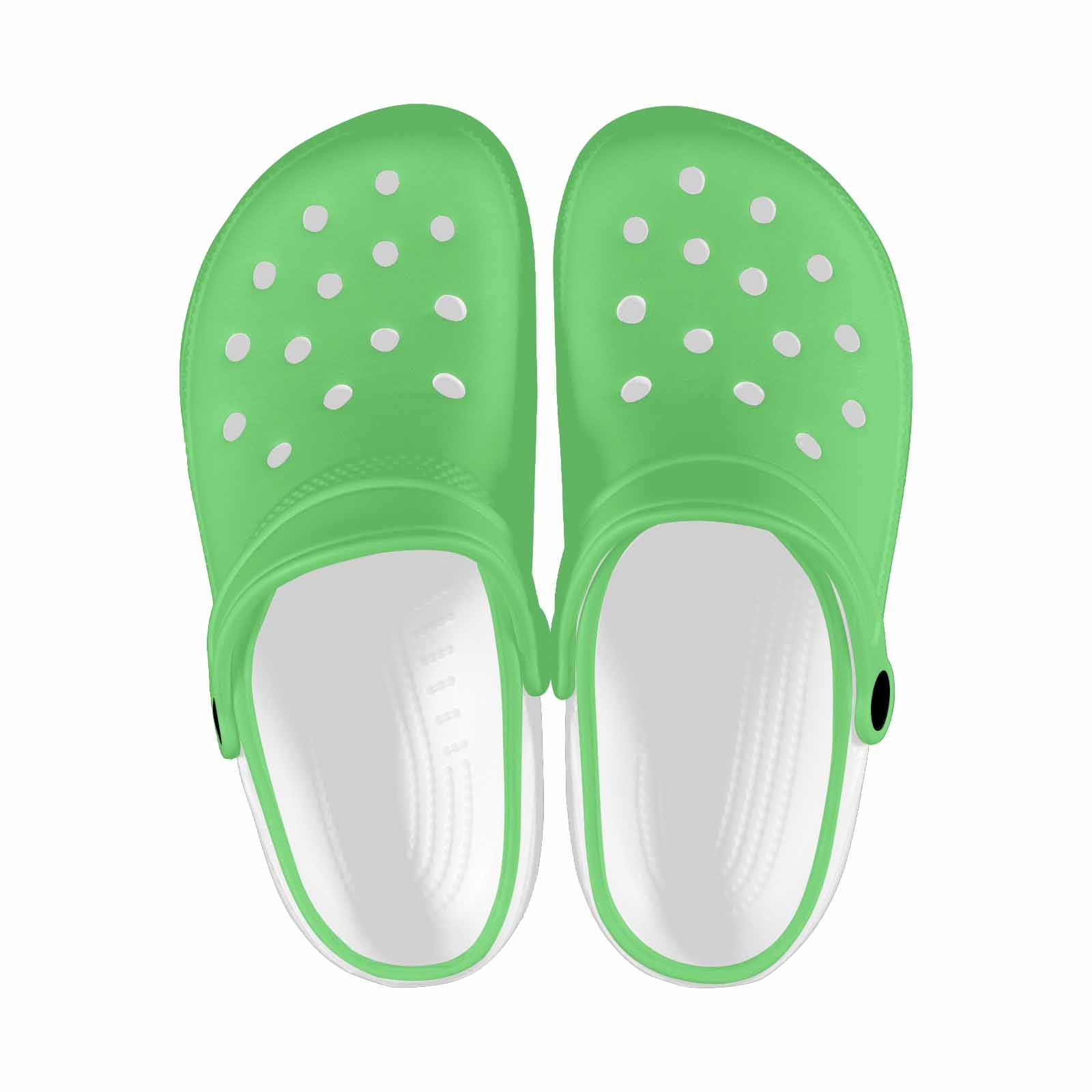 Pastel green adult clogs made from lightweight EVA material, featuring ventilation ports and pivoting heel straps for a secure fit.