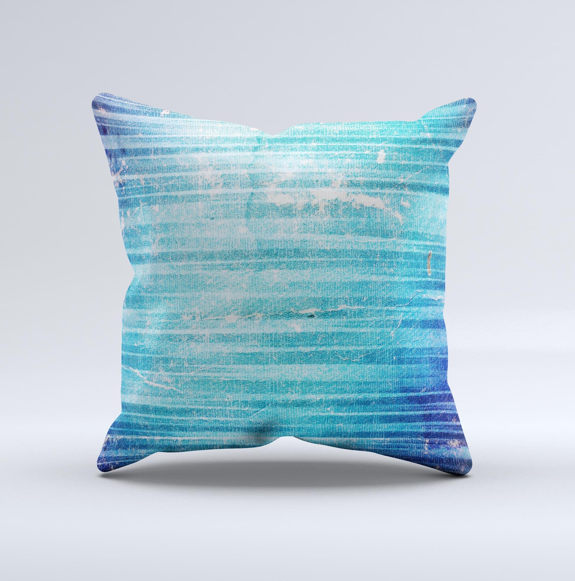 A vibrant blue decorative throw pillow with a unique patchy folded design, handcrafted in Virginia, showcasing artistic ink-fused graphics.