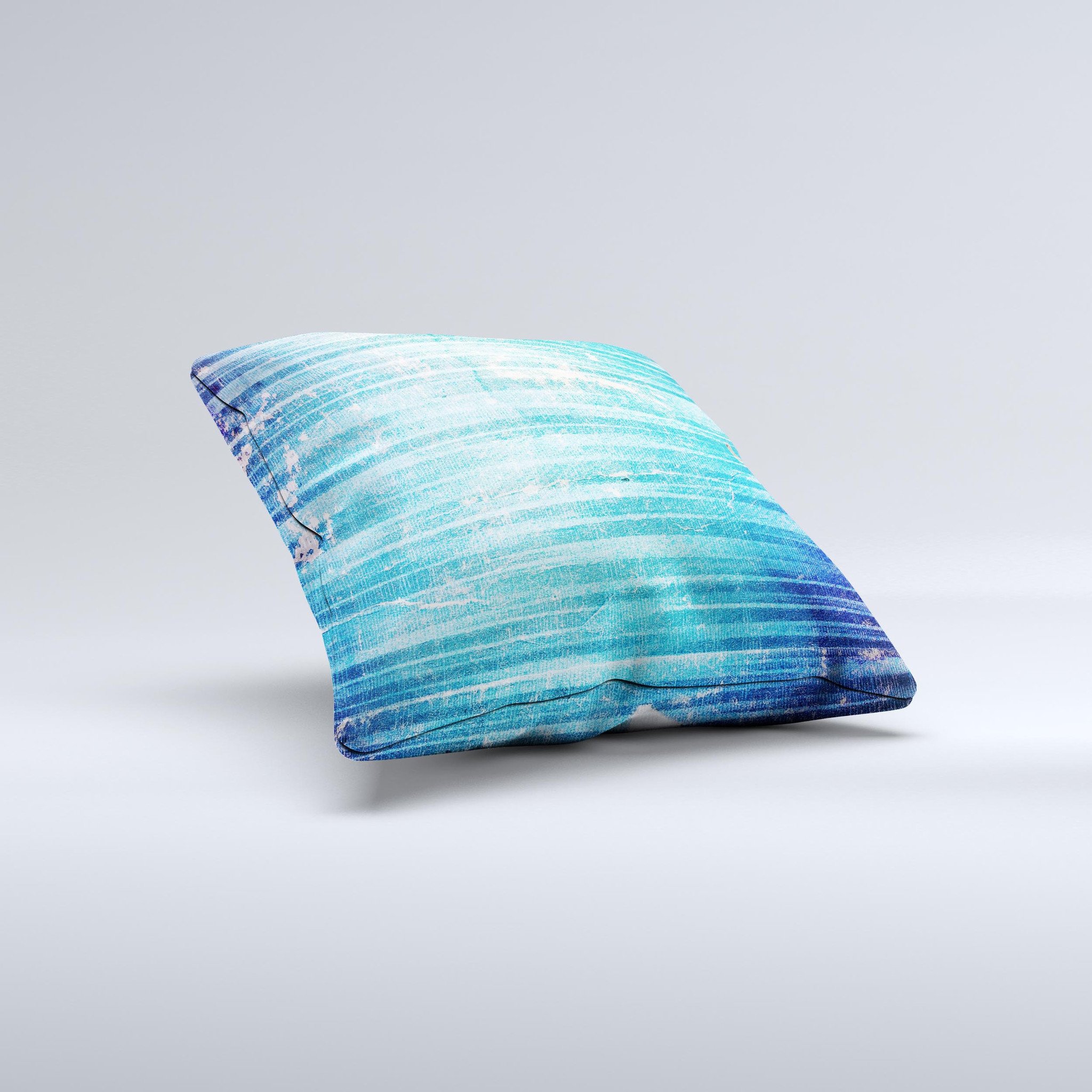 A vibrant blue decorative throw pillow with a unique patchy folded design, handcrafted in Virginia, showcasing artistic ink-fused graphics.