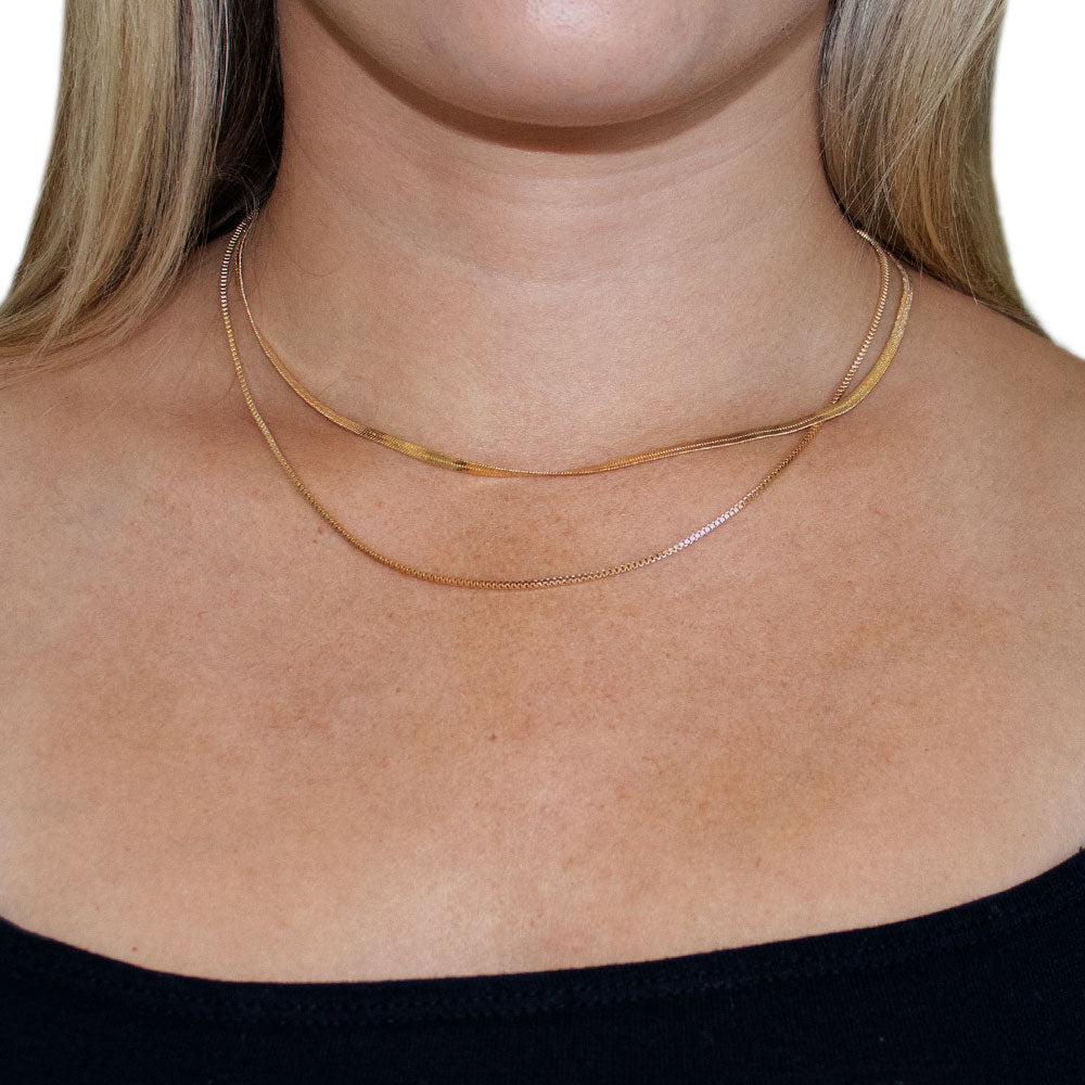 Penelope Layered Herringbone Chain Necklace featuring a double-layered design in 18K gold plated alloy.