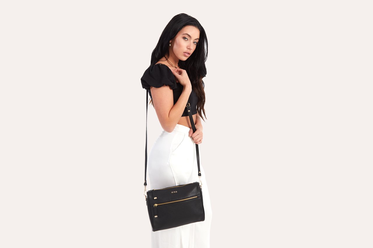 A stylish Perfect Crossbody bag made from genuine pebble leather, featuring an adjustable strap and multiple pockets for organization.