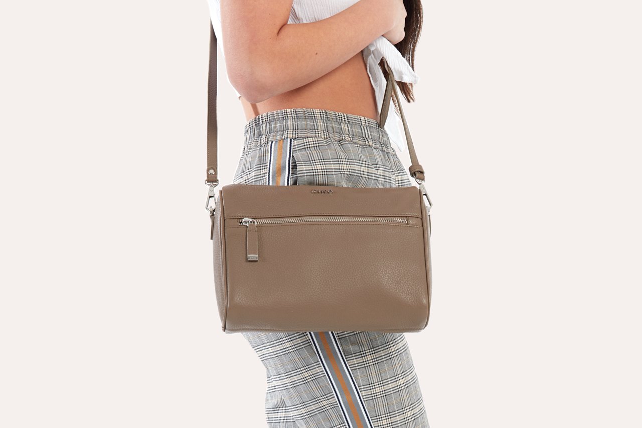 A stylish Perfect Crossbody bag made from genuine pebble leather, featuring an adjustable strap and multiple pockets for organization.