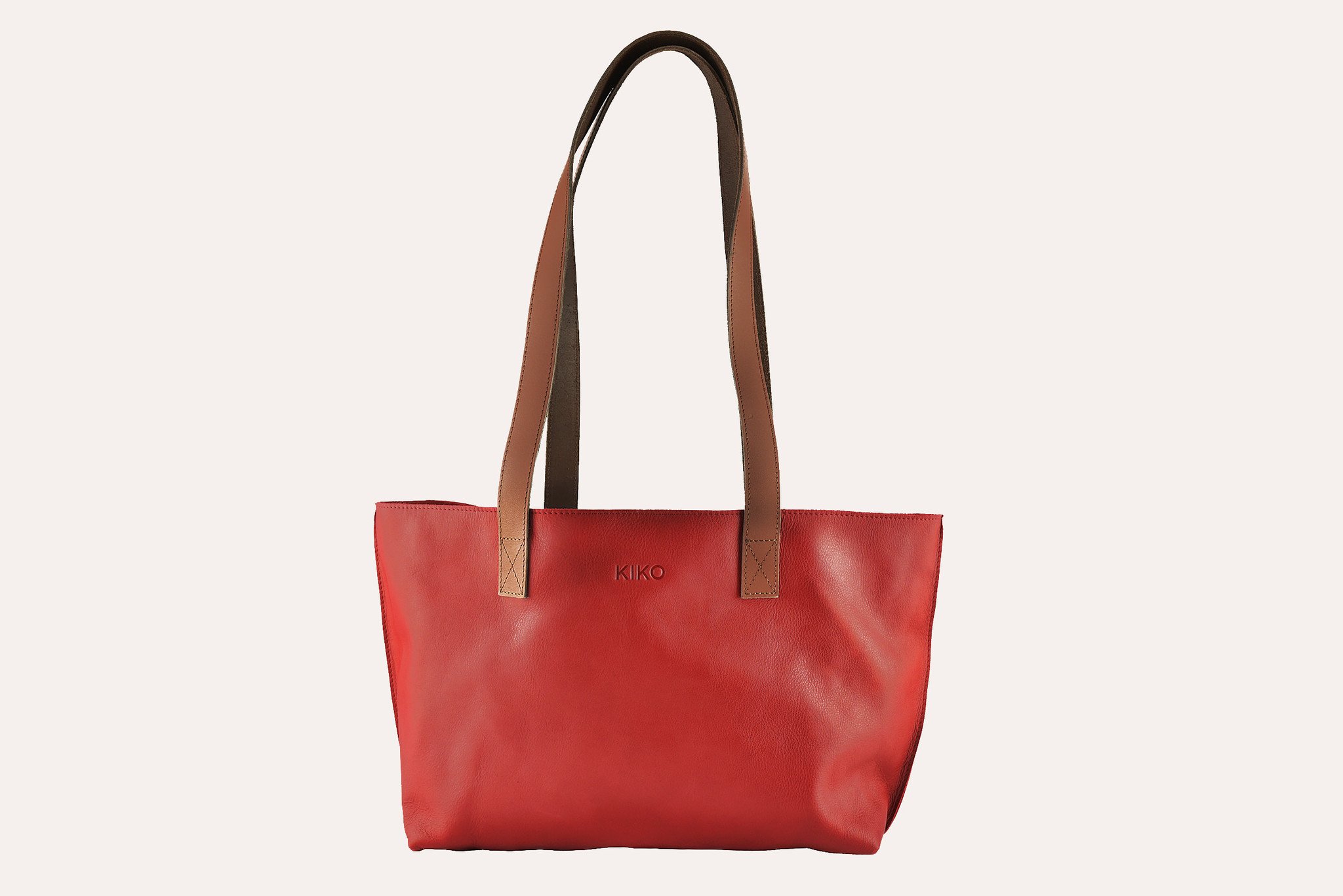 A stylish red tote bag made of genuine leather with a bowl-shaped design and comfortable shoulder handles.