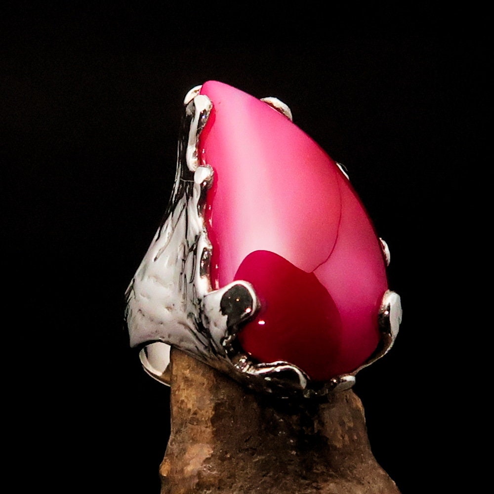 A beautiful Pink Agate Ring set in polished sterling silver, showcasing a unique cabochon design that highlights its vibrant pink color.