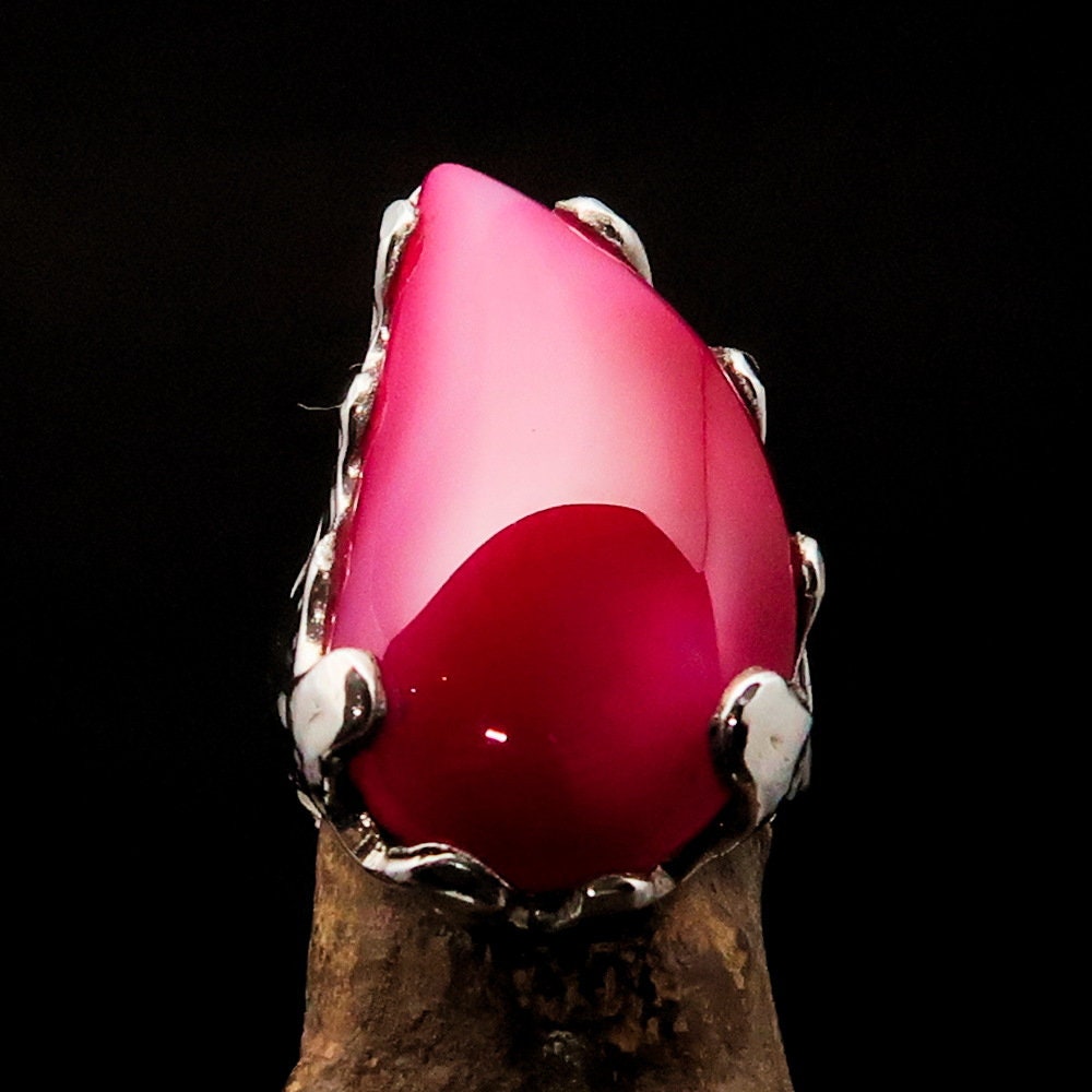 A beautiful Pink Agate Ring set in polished sterling silver, showcasing a unique cabochon design that highlights its vibrant pink color.