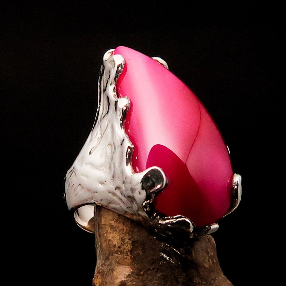 A beautiful Pink Agate Ring set in polished sterling silver, showcasing a unique cabochon design that highlights its vibrant pink color.