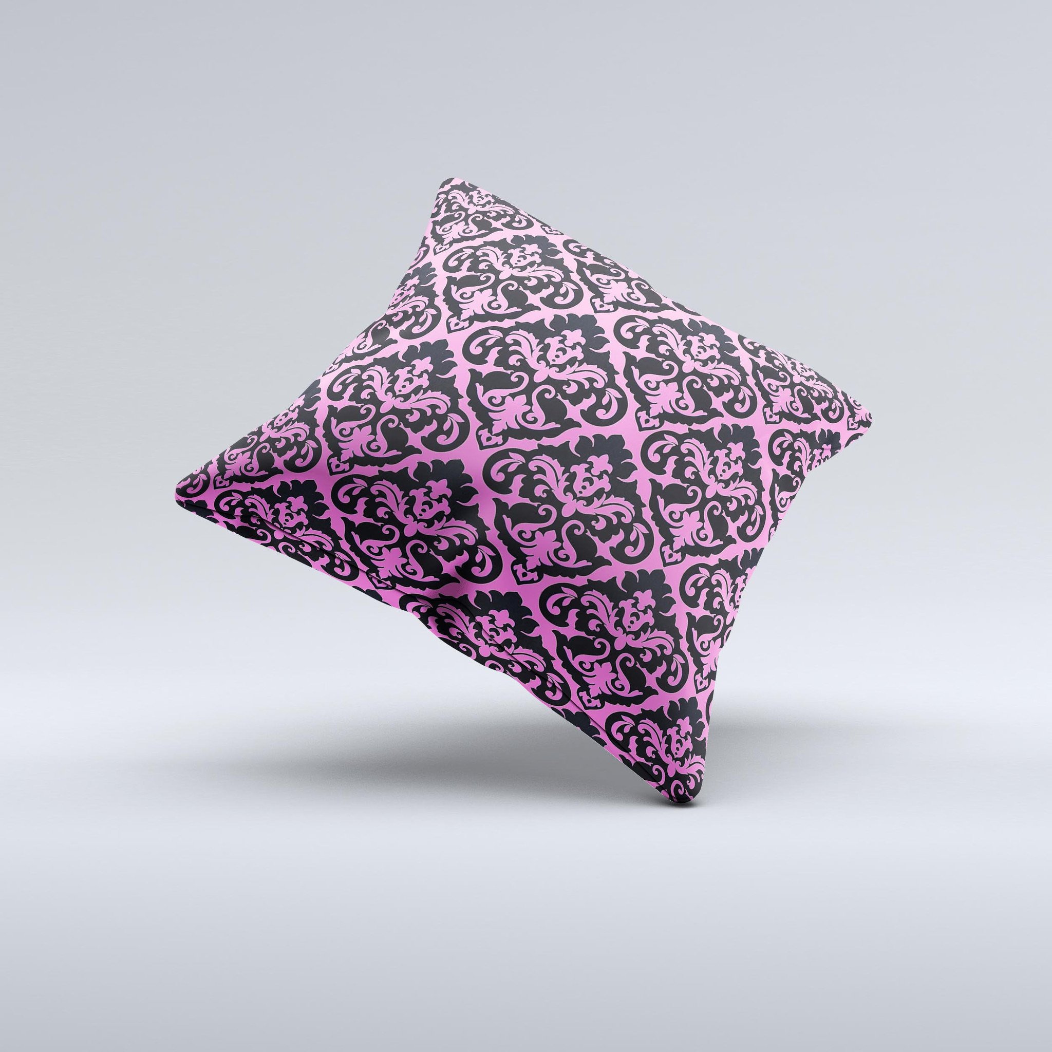 Pink and black decorative throw pillow with a delicate pattern, handcrafted in Virginia, showcasing unique ink-fuzed design.