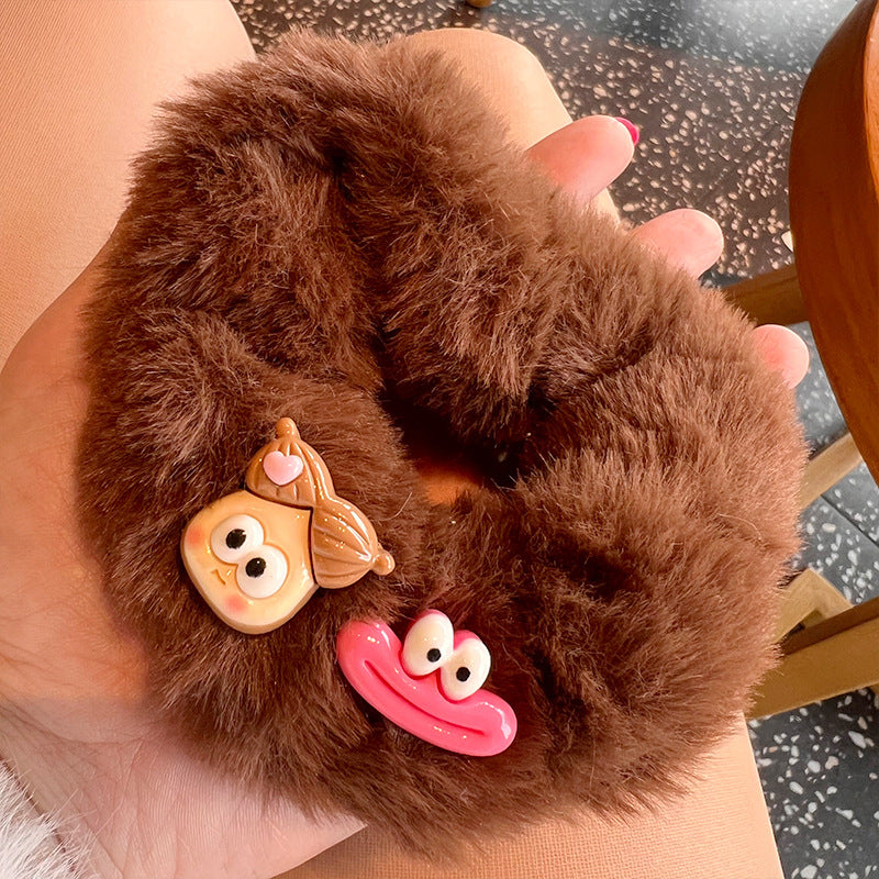 A cute pink and brown plush clown hair tie featuring fuzzy gloves, perfect for adding a playful touch to hairstyles.