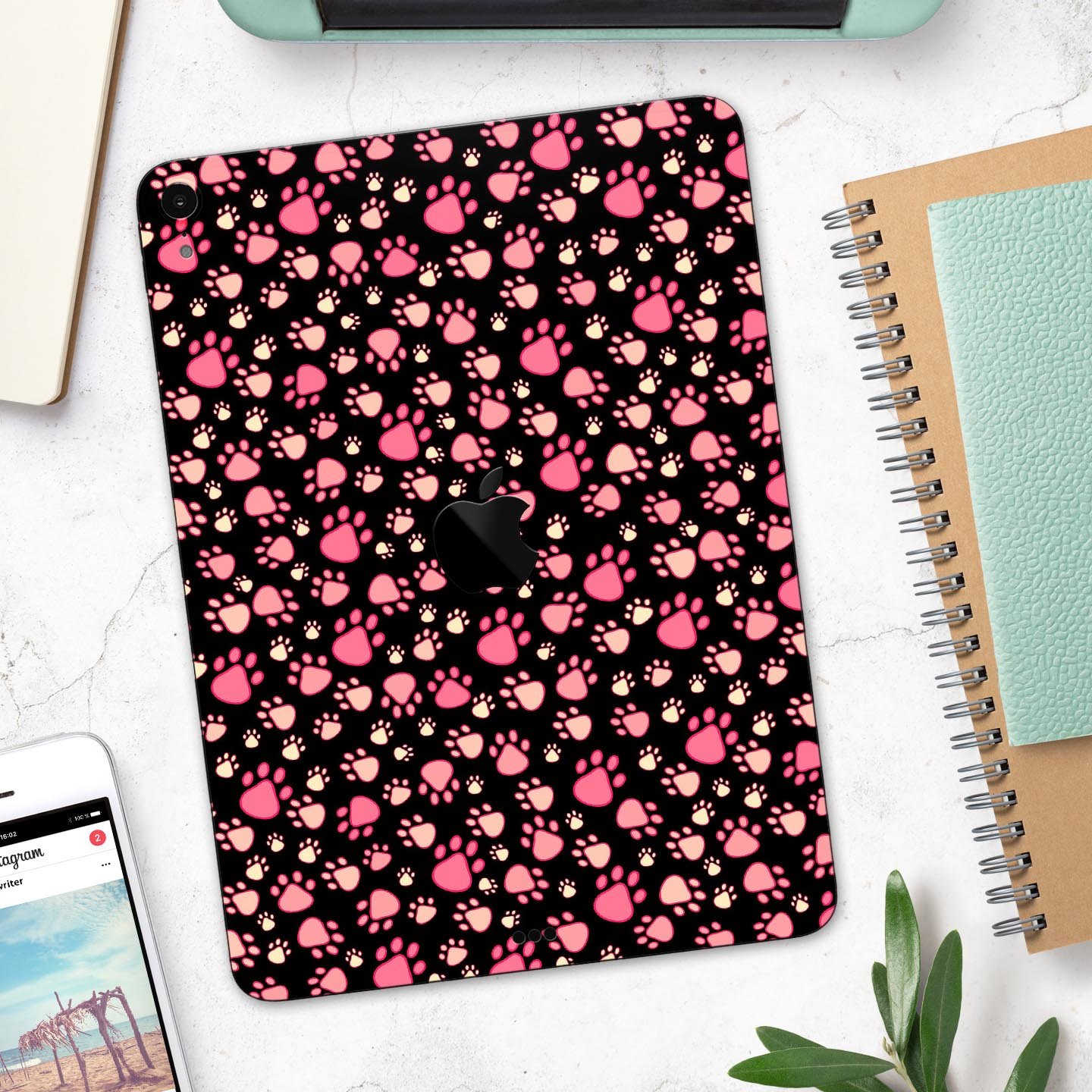 Full body skin decal featuring pink paw prints on a black background designed for Apple iPad Pro, showcasing its stylish and protective features.