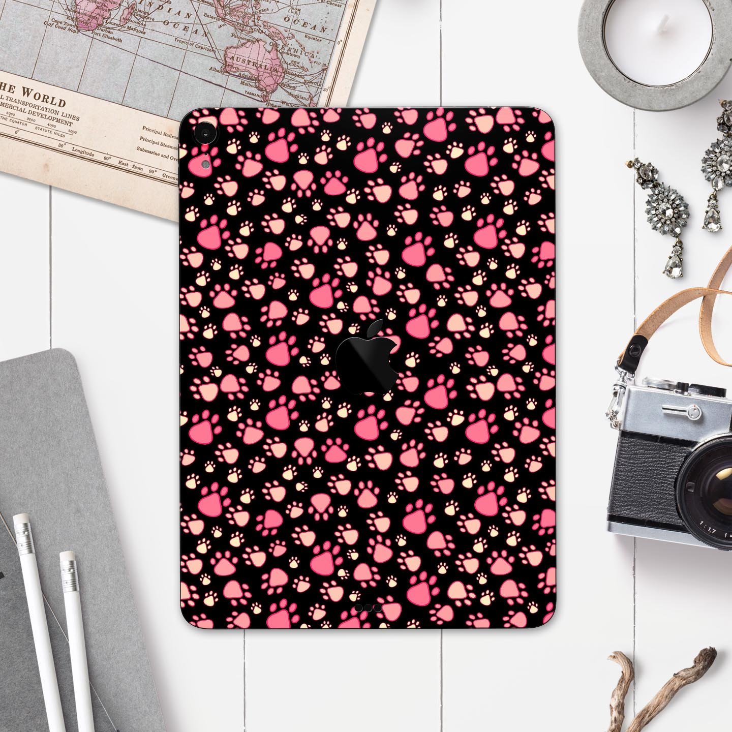 Full body skin decal featuring pink paw prints on a black background designed for Apple iPad Pro, showcasing its stylish and protective features.