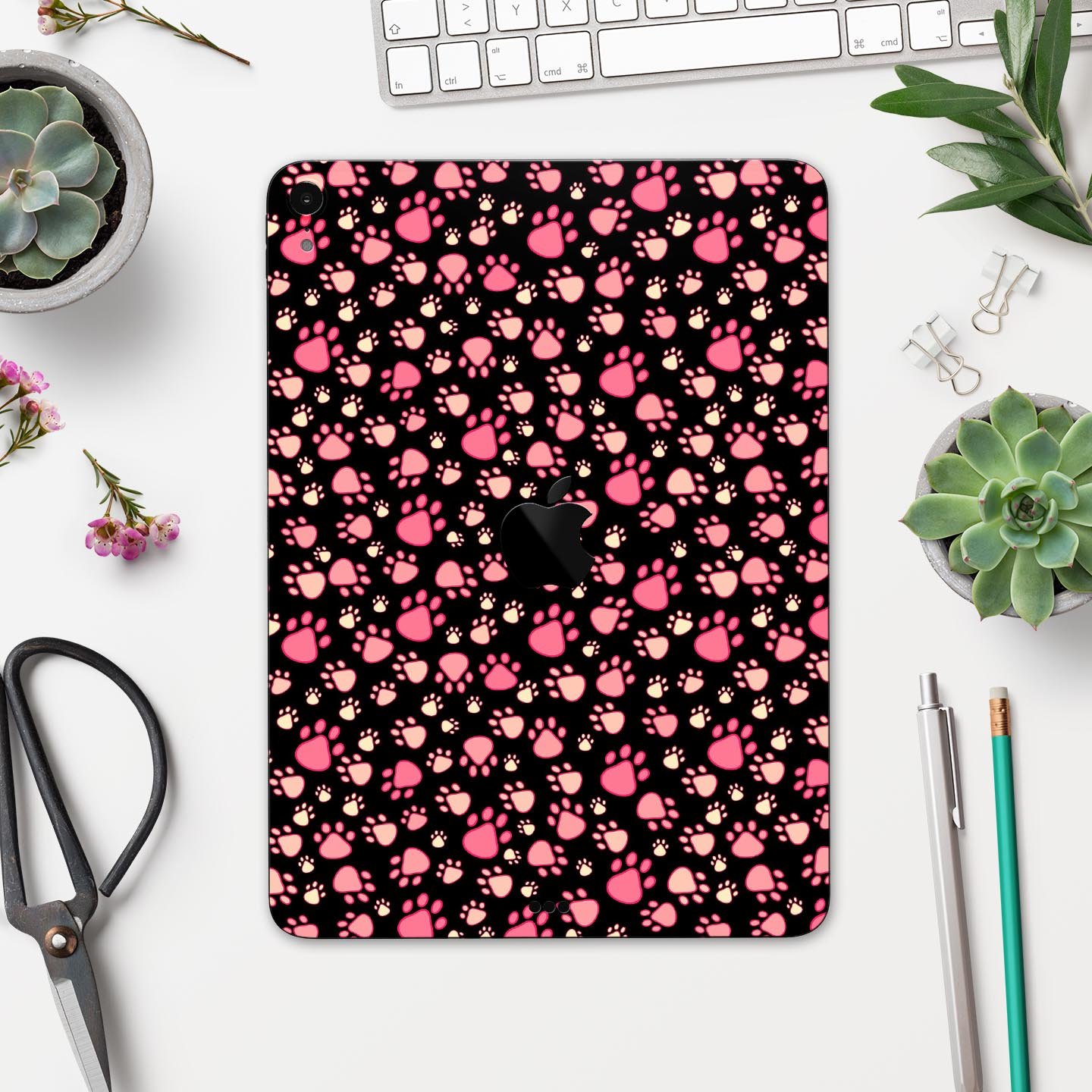 Full body skin decal featuring pink paw prints on a black background designed for Apple iPad Pro, showcasing its stylish and protective features.