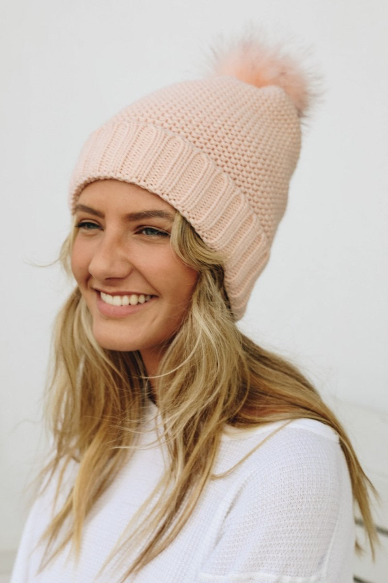 Cozy Pom Beanie with soft faux sherpa lining, perfect for winter wear.