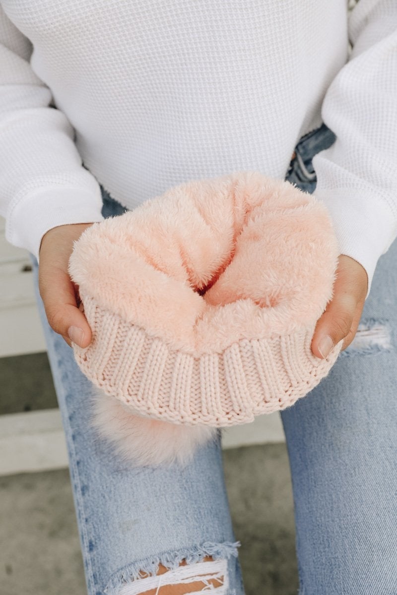 Cozy Pom Beanie with soft faux sherpa lining, perfect for winter wear.