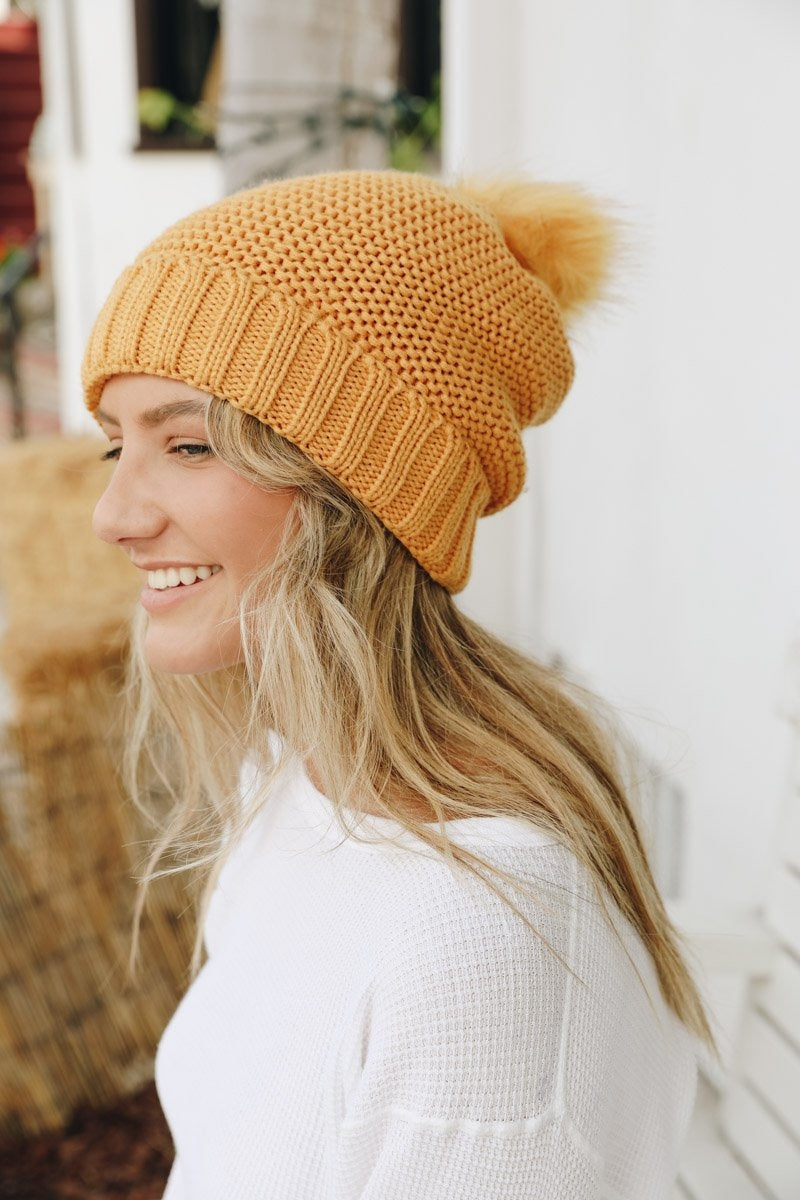 Cozy Pom Beanie with soft faux sherpa lining, perfect for winter wear.