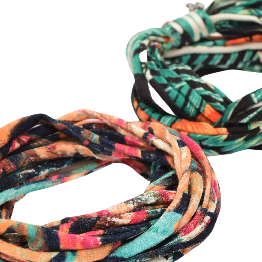 Two stylish Prints + Patterned Bela Bands in vibrant colors, showcasing their versatility as headbands and bracelets.