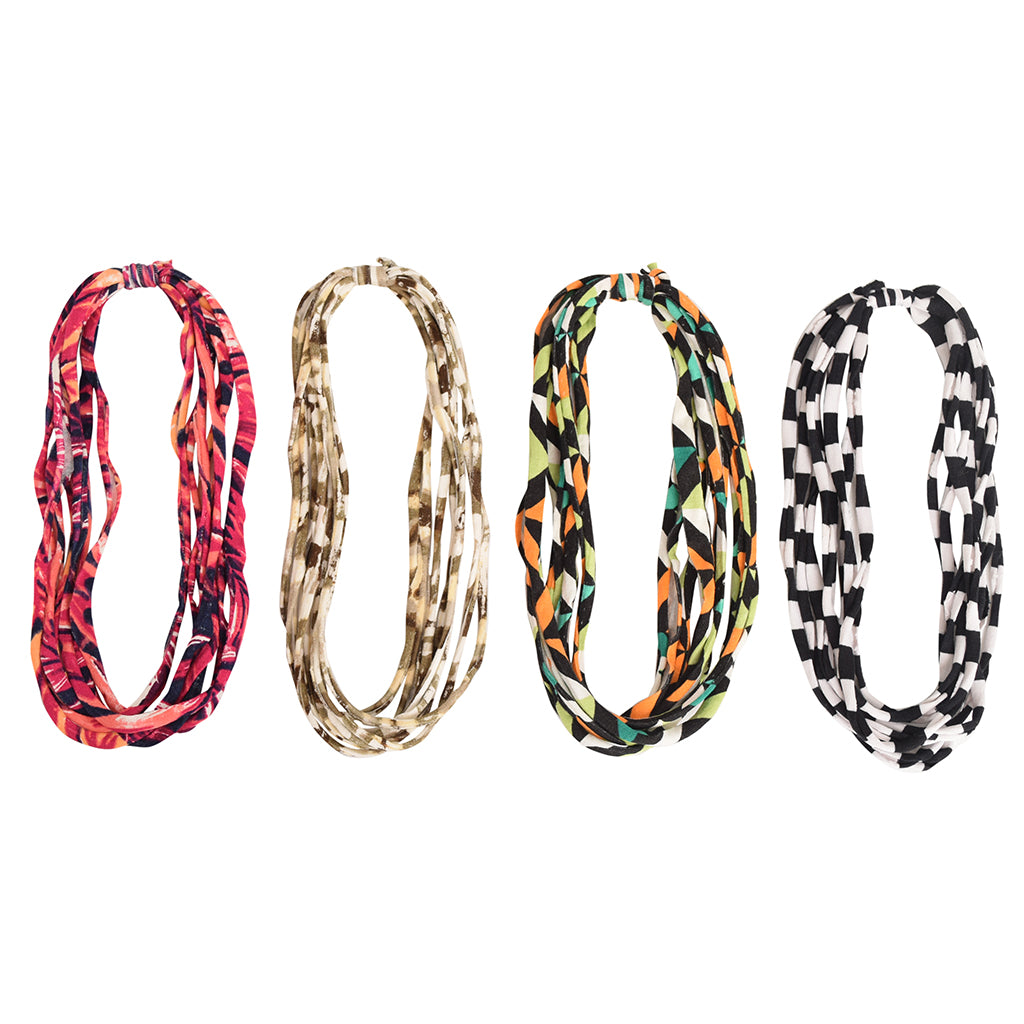 A colorful assortment of Prints + Patterns Bela Bands, showcasing their versatility as headbands and bracelets.