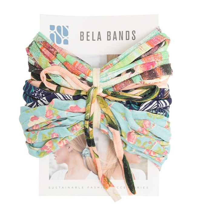 A colorful assortment of Prints + Patterns Bela Bands, showcasing their versatility as headbands and bracelets.