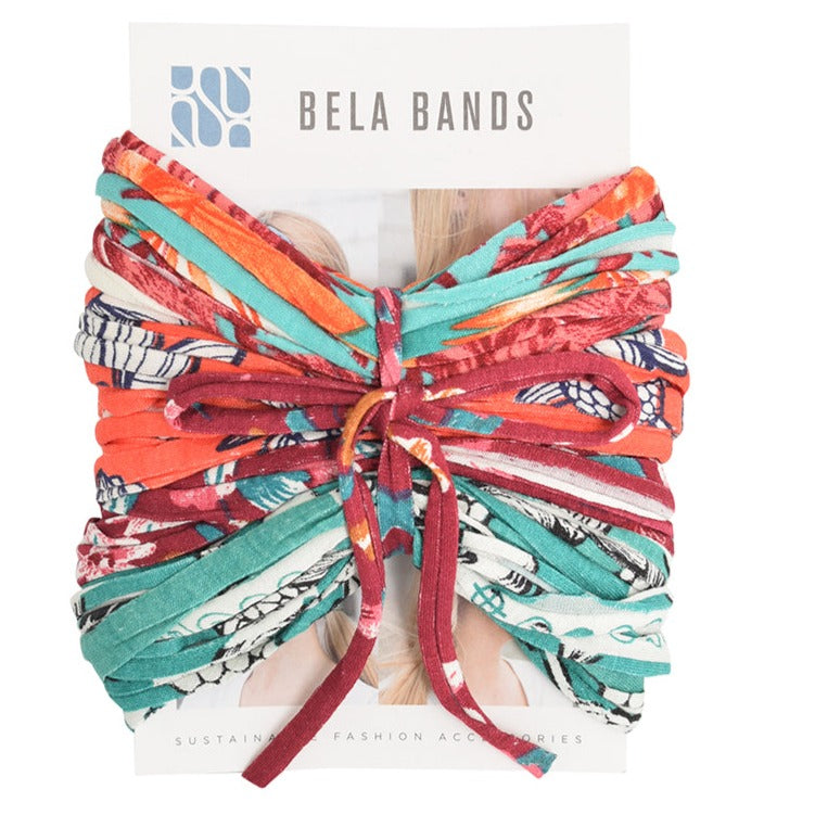 A colorful assortment of Prints + Patterns Bela Bands, showcasing their versatility as headbands and bracelets.