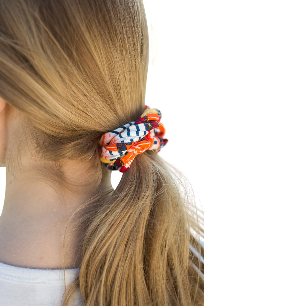 A colorful assortment of Prints + Patterns Bela Bands, showcasing their versatility as headbands and bracelets.