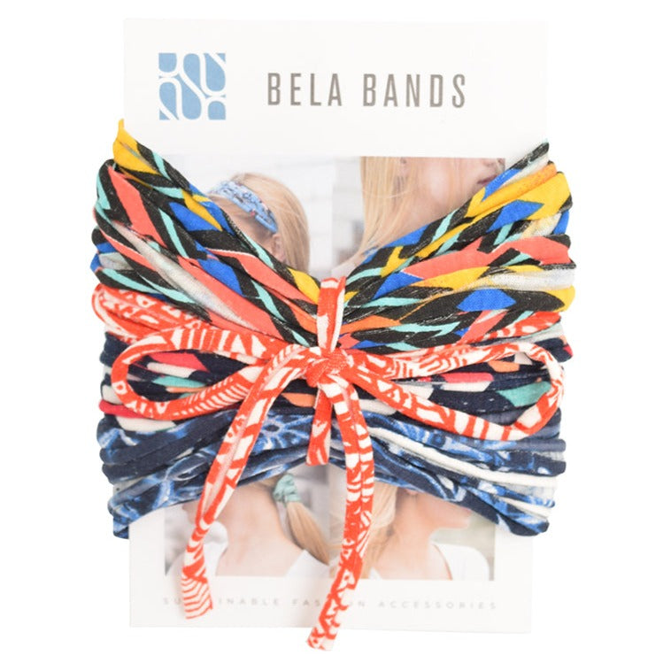 A colorful assortment of Prints + Patterns Bela Bands, showcasing their versatility as headbands and bracelets.