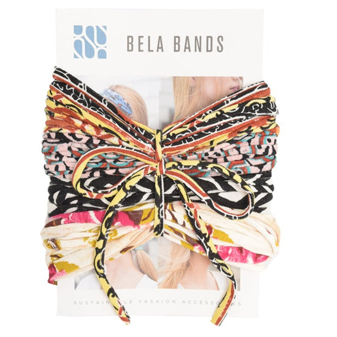 A colorful assortment of Prints + Patterns Bela Bands, showcasing their versatility as headbands and bracelets.