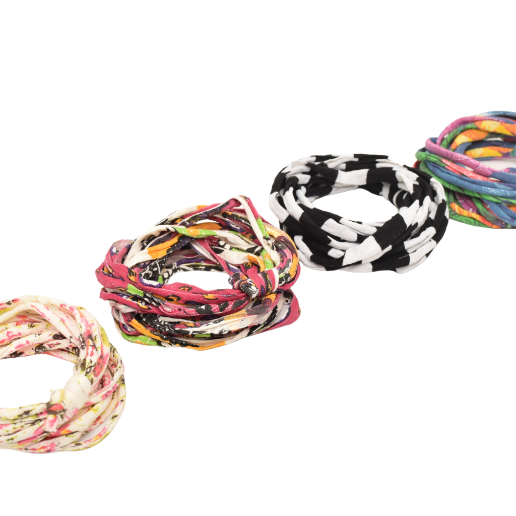 A colorful assortment of Prints + Patterns Bela Bands, showcasing their versatility as headbands and bracelets.