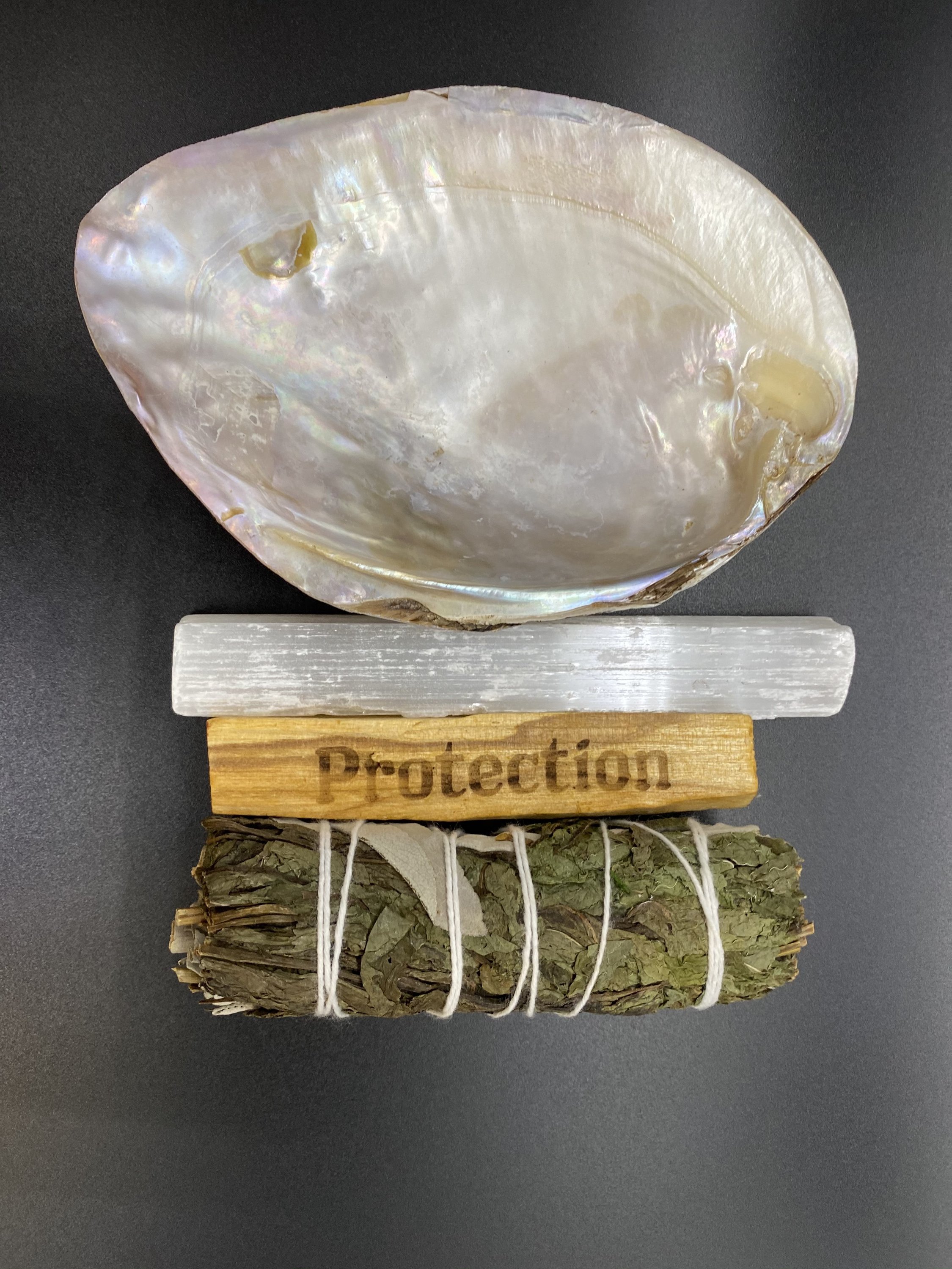 Protection Smudge Kit featuring Selenite crystal, Palo Santo stick, and Peppermint Sage for space cleansing.