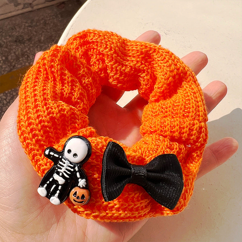 Pumpkin color cute ghost hair tie featuring a vibrant ghost design, perfect for Halloween celebrations.