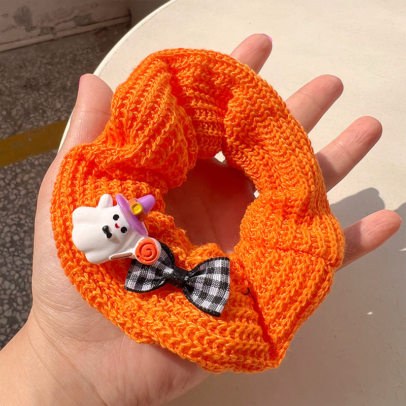 Pumpkin color cute ghost hair tie featuring a vibrant ghost design, perfect for Halloween celebrations.