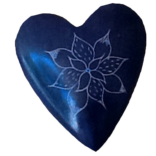 A beautifully hand-carved purple soapstone heart featuring intricate etched flower designs, symbolizing Haitian craftsmanship and artistry.