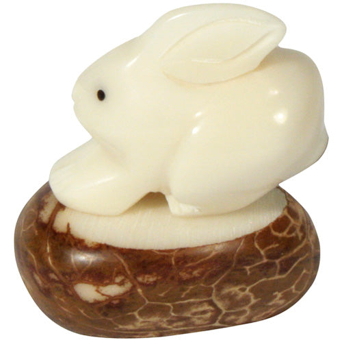 Hand-carved rabbit figurine made from tagua nut, showcasing natural colors and intricate details, symbolizing eco-friendly craftsmanship.