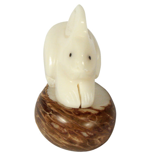 Hand-carved rabbit figurine made from tagua nut, showcasing natural colors and intricate details, symbolizing eco-friendly craftsmanship.