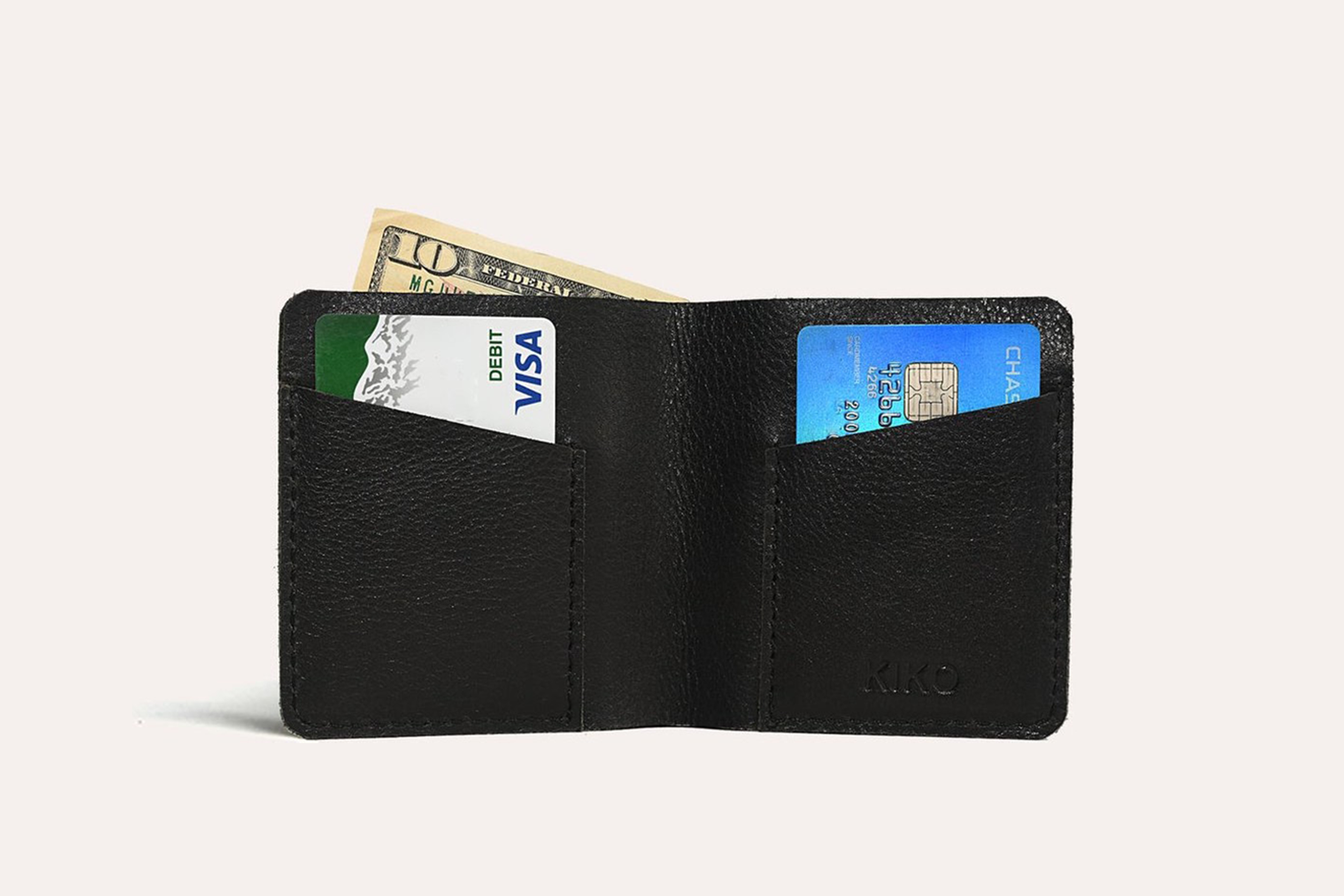 A sleek black leather Ram Wallet with two card slots and a bill compartment, showcasing its minimalistic design.