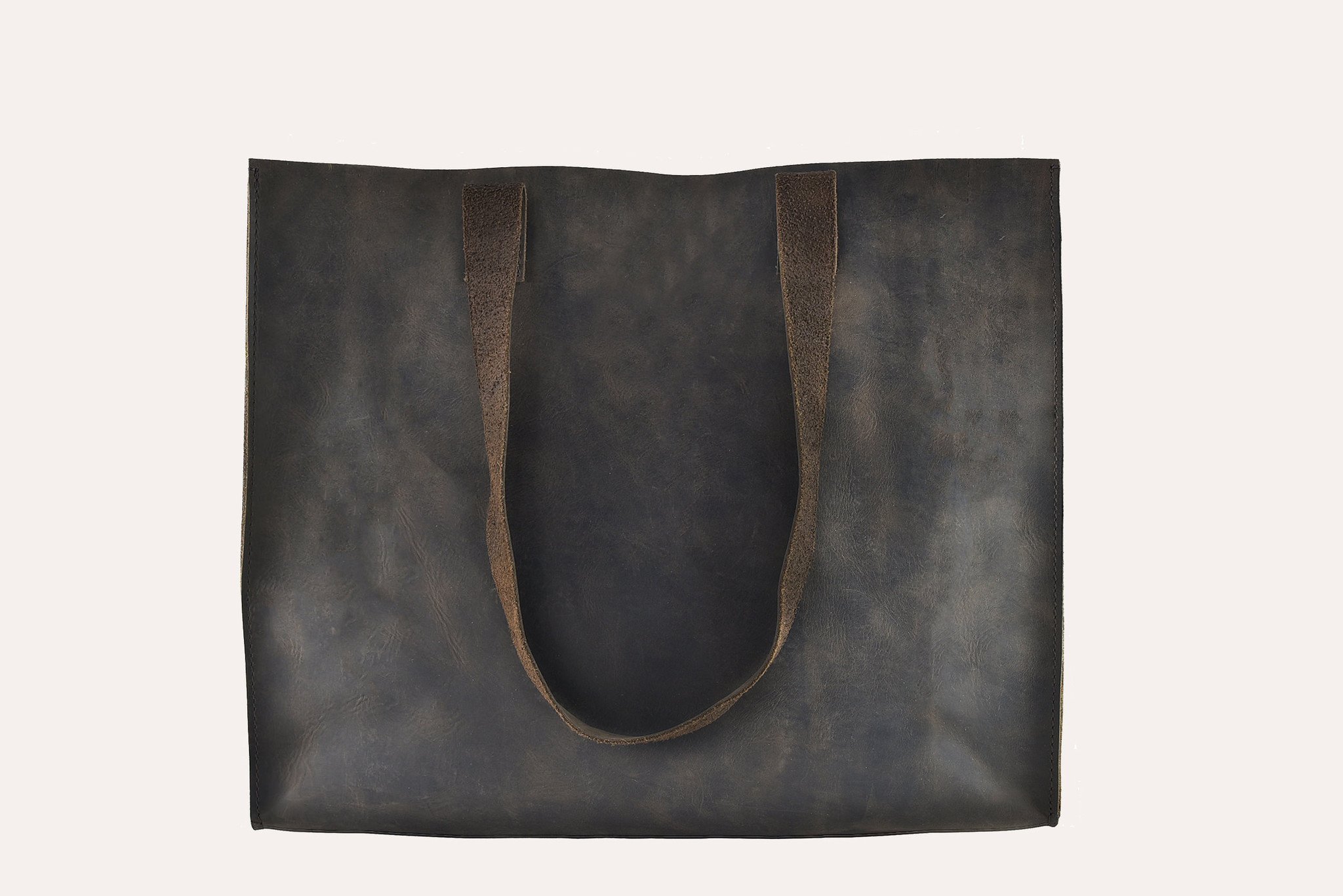 A stylish Raw Edge Tote made from top grain cowhide leather with a marbled mocha finish and unlined interior.