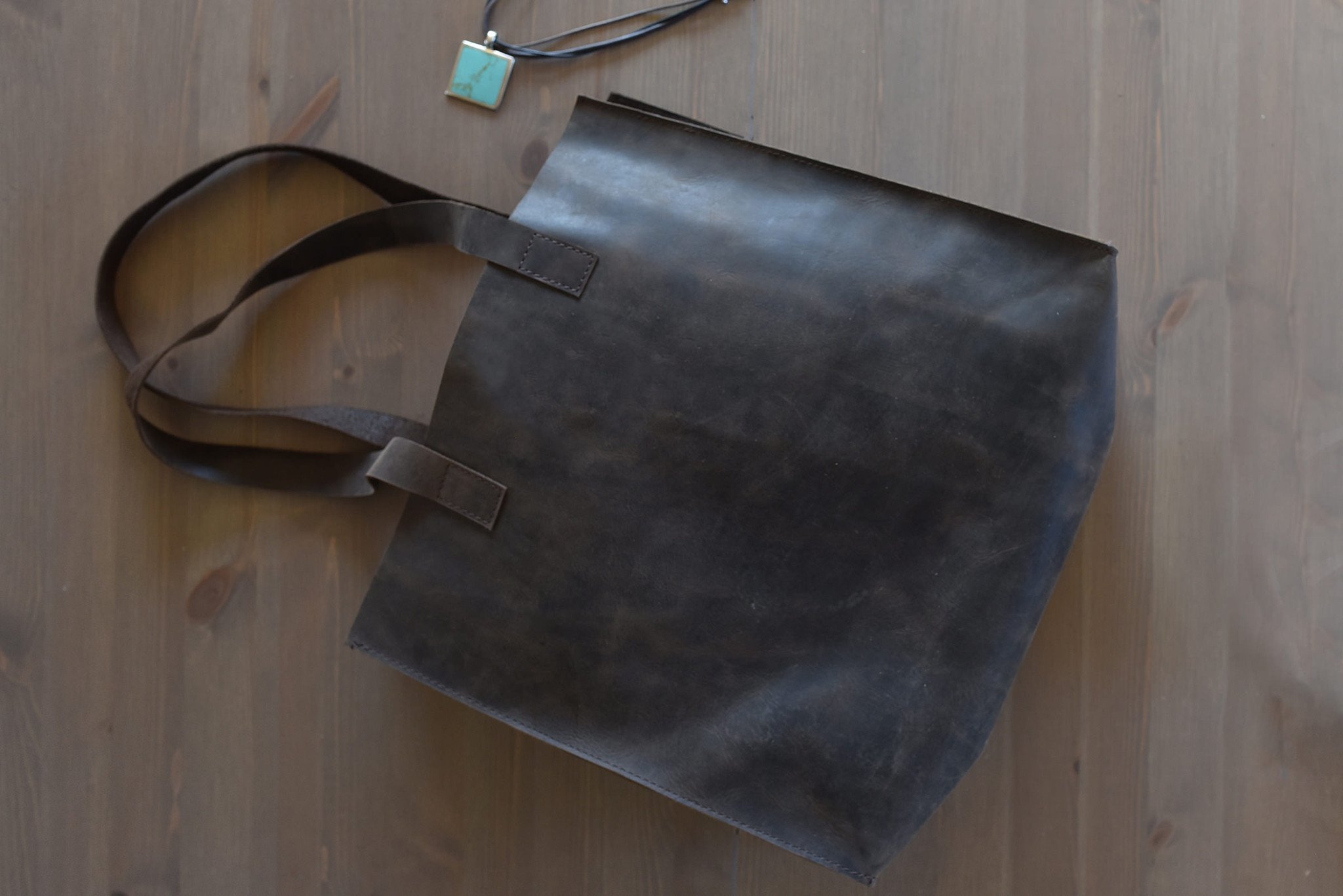 A stylish Raw Edge Tote made from top grain cowhide leather with a marbled mocha finish and unlined interior.