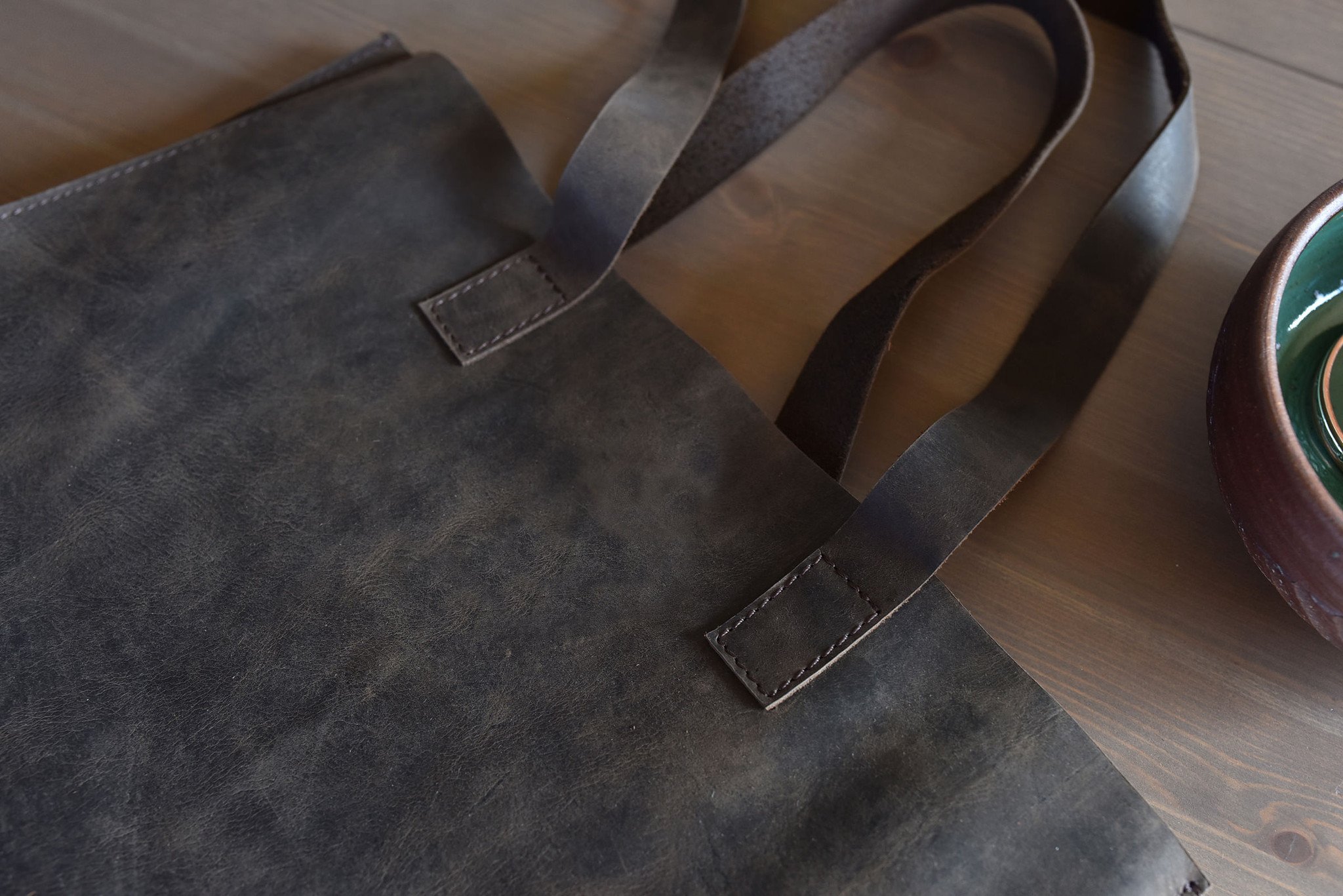 A stylish Raw Edge Tote made from top grain cowhide leather with a marbled mocha finish and unlined interior.